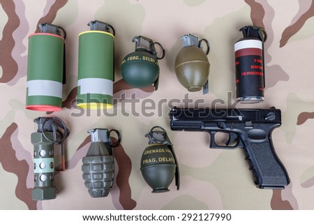 All explosives, weapon army,standard time fuze, hand grenade and gun on camouflage background, top view