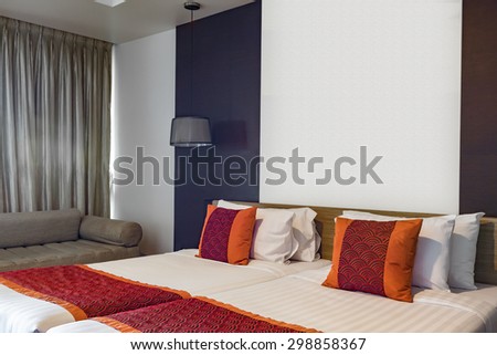 BANGKOK THAILAND - JUNE 18 : Red pillow on double bedroom with white bed sheet and lamp light off, in Spring Field at Sea hotel in Cha-am Phetchaburi, Thailand on June 18, 2015