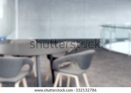 abstract office with meeting round table and black office chairs for conference, blur background
