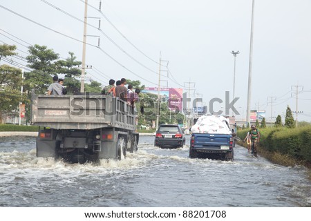 BANGKOK THAILAND - NOVEMBER 5 : Vehicles transport food supplies to help people impacted from flooding, in Pathumtani, Thailand on November 5, 2011
