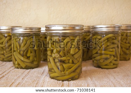 Home canned green beans cooling on the kitchen counter