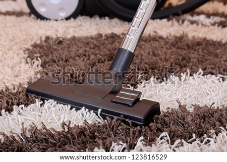 vacuum cleaner on fluffy carpet