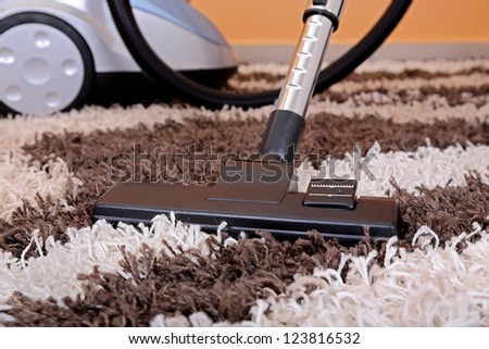 vacuum cleaner on fluffy carpet