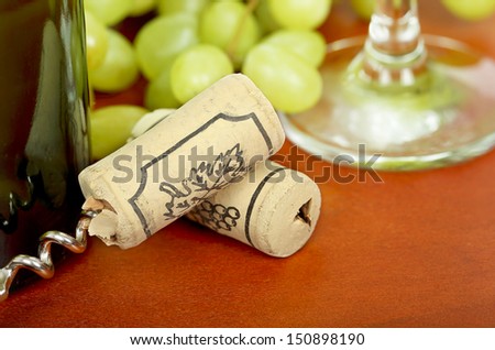 bottle corks on wood next to a wine bottle