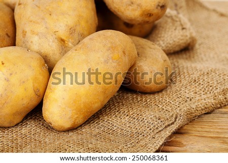 heap of fresh potatoes on burlap sack