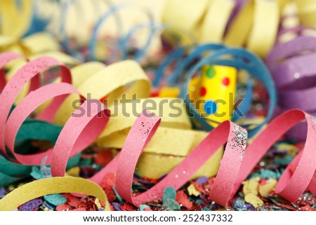 closeup of colorful party streamers on confetti