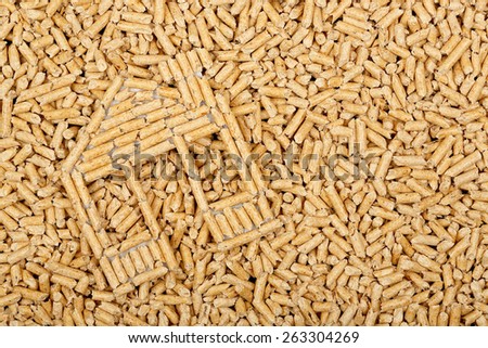 wood pellets in the shape of a house on wood pellets surface, full frame