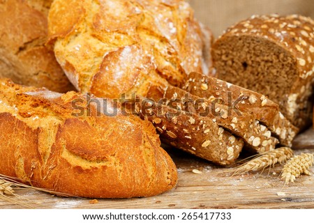 loaves of whole wheat bread on wooden surface