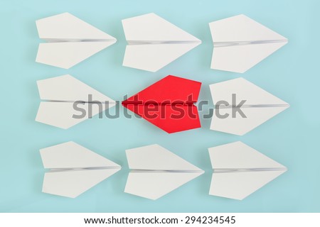 being different concept with red paper plane going in a different direction