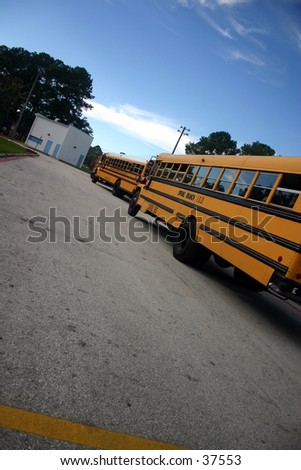 Buses at the school waiting for the kids to get on