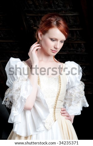 Redhead young woman dressed up like cinderella at attic