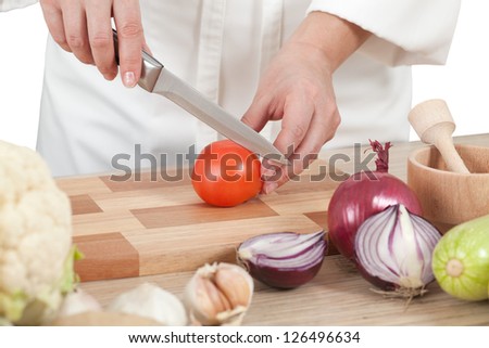 Woman chef chops vegetables for cooking