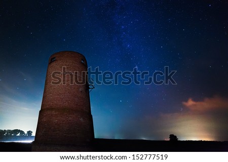 Milky Way in the background of the old tower