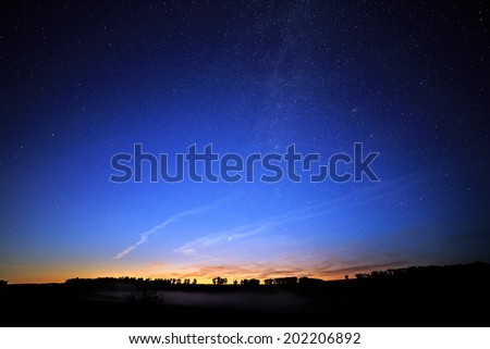 Dawn on a starry background sky and the Milky Way.