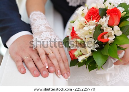 Hand of the groom and the bride with wedding rings at a wedding party