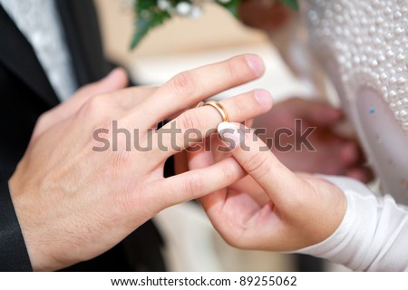 stock photo Newlymarried couple on wedding dresses gold rings