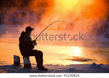 Fishing in the winter on not frozen reservoir