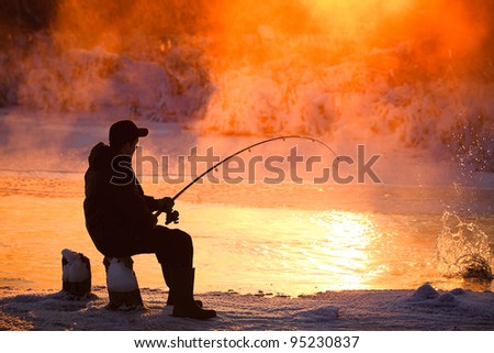 Fishing in the winter on not frozen reservoir