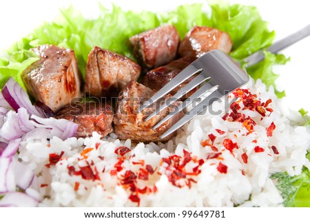 fork on a dish with rice and meat