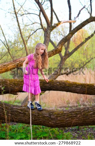 Lonely sad scared toddler girl in pink dress lost in forest try to find way back home