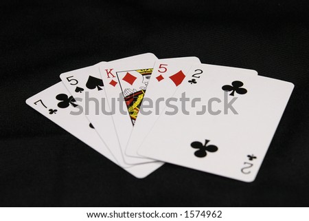 A hand of cards against a black background