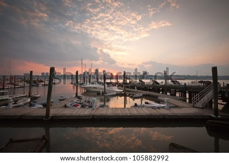 Wide angle sunset on the west side boat dock on the Hudson River in New York City.
