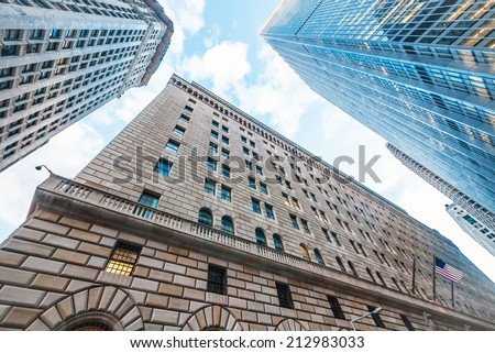 The Federal Reserve Bank of New York, upward view, and surrounding buildings.