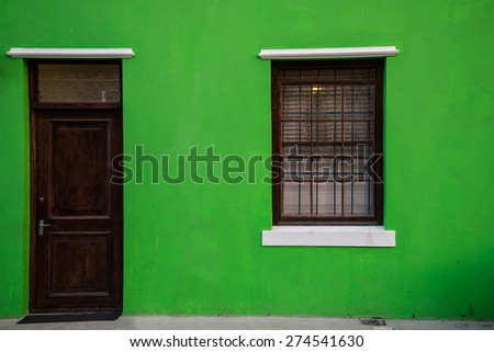 Colorful green home facade in the historic Bo-Kaap neighborhood in Cape Town, South Africa.  The area is also known as the Malay Quarter, known for its colorful homes.