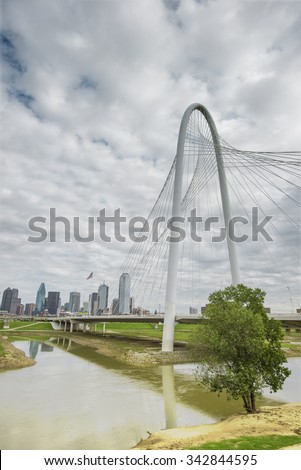 Modern design suspension Margaret Hunt Hill Bridge and the Dallas skyline in the distant background