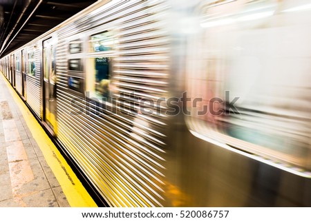 New York City subway train leaving its station - motion blur as