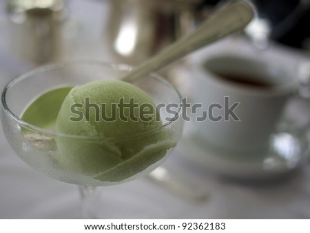 Green tea sorbet and tea in the background on a high tea table