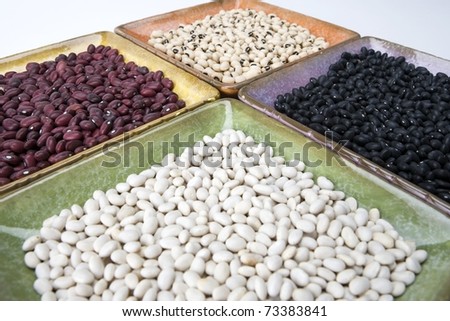 Mixed dried beans in coloreful square dishes
