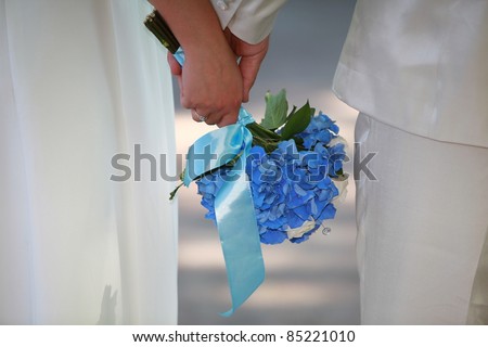 just married: hands, rings  and flowers