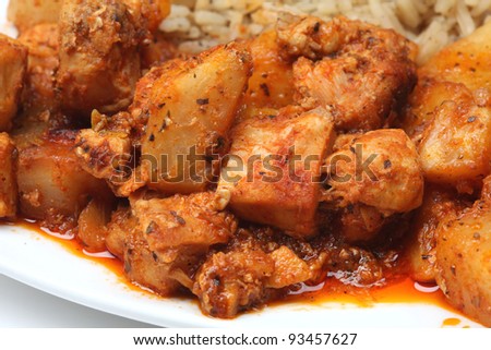 chopped chicken cooked in a sweet and sour sauce with rice, chinese food