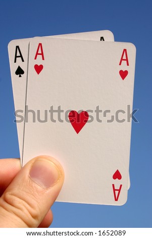Holding two aces with a blue sky