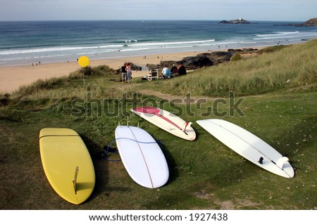 Surf boards and people watching a surf competition, Gwithian sands, Cornwall