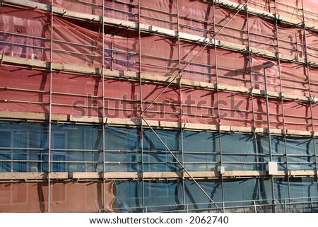A new building covered in scaffolding and tarpaulin