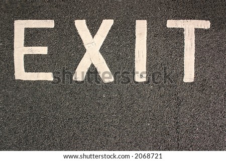 White car park exit sign on black tarmac