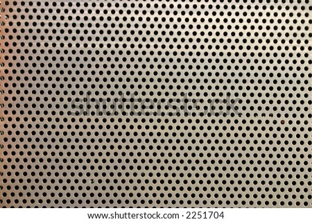 Metal fence with round holes, makes an interesting abstract background.