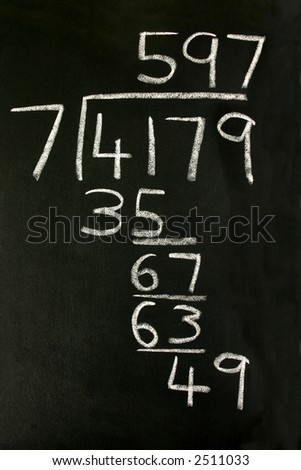 A long division sum on a blackboard.