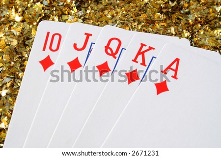 A royal flush with a gold glitter background.