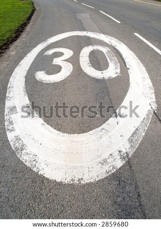 30 mph sign on a tarmac road.