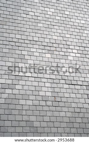 A large wall covered in gray slates.