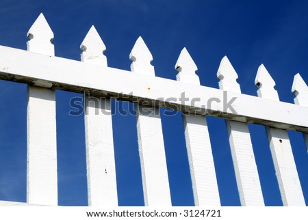A white picket fence and a dark blue sky.