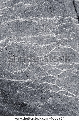 Natural gray granite stone with white lines background.