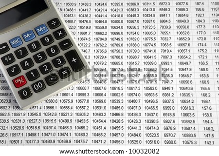 A calculator on a business data sheet print out.