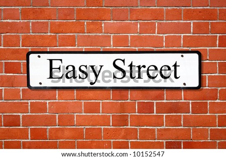 Easy street sign on a brick wall.