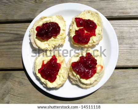 Cornish cream tea.  Strawberry jam and clotted cream scones on a park picnic bench.