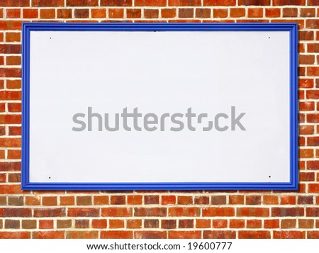 Large white blank billboard sign with a blue wooden frame on a red brick wall.
