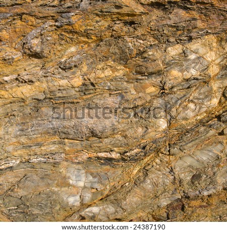 Weathered coast cliff rock face abstract background.